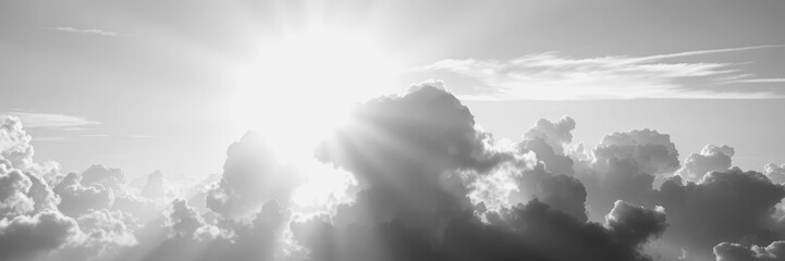 Bright sunlight breaking through clouds at twilight in black and white