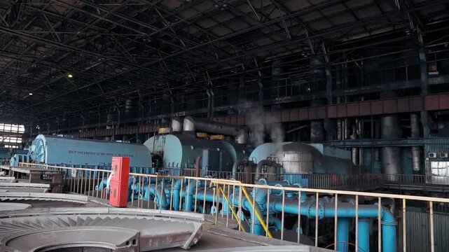 The engine turbine room of an old Soviet power plant. Steam turbine at coal-fired power plant to produce rotation for generator.