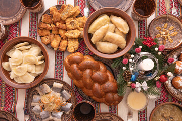 Traditional Ukrainian Christmas Eve dinner with twelve dishes on festive table, top view, free space for text