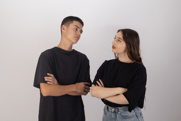 Man and woman standing in front of white wall