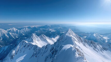 Snow Covered Mountain Peaks under Clear Blue Sky in Daylight Alpine Landscape with Shadows and Haze at the Horizon Panorama