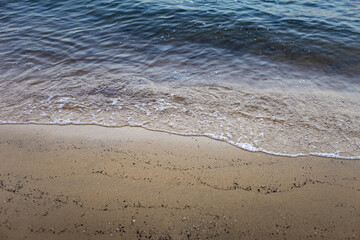 Waves and sea foam on the beach