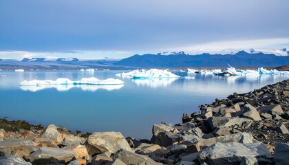 Icebergs on a glacial lake, dramatic mountain backdrop