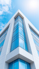 Modern glass building facade with sharp geometric lines against blue sky, symbolizing architecture, business success, innovation and urban progress, with strong perspective and copy space.