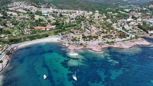 aerial view,  flying along Agay Bay coastline, French Riviera (C&ocirc;te d'Azur) with "Plage du Pourrousset" , Village Cap Est&eacute;rel in Saint-Rapha&euml;l, and panning left to Cap Dramont  - 4k video footage 