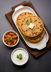 Delicious Stack of Indian Aloo Paratha with Butter, Yogurt, and Mango Pickle.