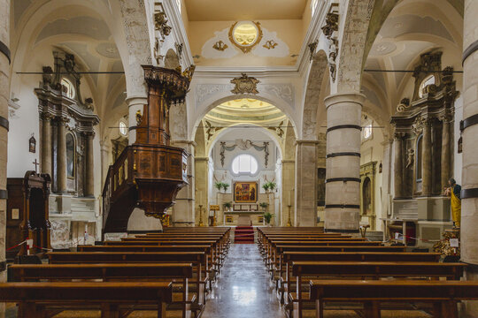 View of the Chiesa di Santa Maria delle Grazie's serene interior, where wooden pews lead to a radiant altar under vaulted ceilings, Anversa degli Abruzzi, Abruzzo, Italy.