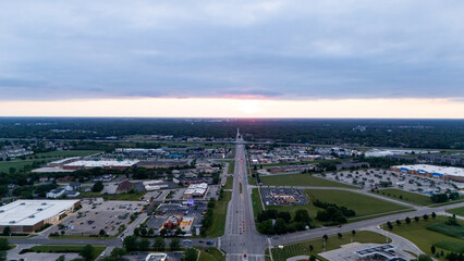 A long, straight road bisects the scene, leading towards a faint horizon