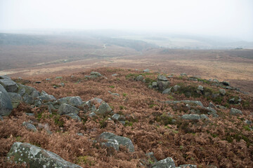 Mist descends and obscures the landscape on a foggy day in the Peak District
