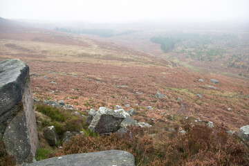 Mist descends and obscures the landscape on a foggy day in the Peak District