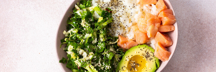 A nutritious breakfast bowl featuring rice, salmon, avocado, and fresh greens is presented beautifully in a bowl. Simple and healthy morning meal idea with vibrant colors, banner