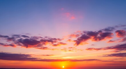 Beautiful sunset sky with dramatic colorful clouds and a vibrant orange glow on the horizon.