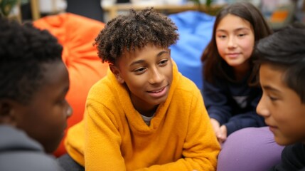 Obraz premium Group of young people sitting together in a casual setting, engaged in conversation.