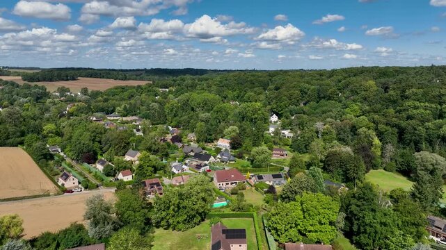 Aerial view of Genappe municipality and city of Wallonia located in the Belgian province of Walloon Brabant. Villas with garden surrounded by forest.
