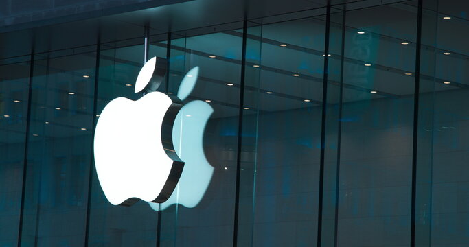 Shanghai, China. Official Store Of Apple, Close Up View. Logo Illumination. Glowing Logo Apple. Apple Authorized Reseller. World Famous Brand. Popular Trademark Founded By Steve Jobs, Steve Wozniak