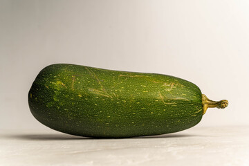 Zucchini vegetable lying on a white background