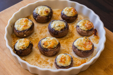baked champignon mushrooms stuffed with herb cream cheese and topped with parmesan. Perfect for illustrating cozy fall appetizers, party snacks