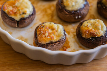 baked champignon mushrooms stuffed with herb cream cheese and topped with parmesan. Perfect for illustrating cozy fall appetizers, party snacks
