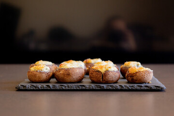 baked champignon mushrooms stuffed with herb cream cheese and topped with parmesan. Perfect for illustrating cozy fall appetizers, party snacks