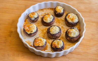 baked champignon mushrooms stuffed with herb cream cheese and topped with parmesan. Perfect for illustrating cozy fall appetizers, party snacks