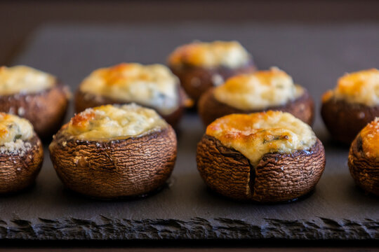 baked champignon mushrooms stuffed with herb cream cheese and topped with parmesan. Perfect for illustrating cozy fall appetizers, party snacks