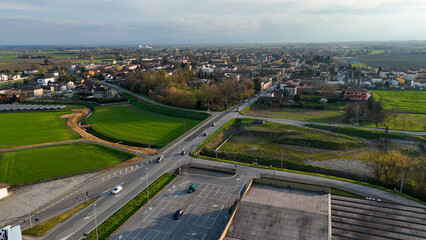 Fototapeta premium Panoramic aerial view of Castelvetro Piacentino and surrounding countryside with SS 10 highway and agricultural fields in the Piacenza region of Italy captured on a clear day