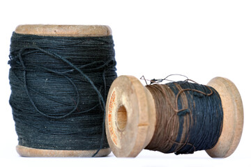 Vintage wooden thread spools on white background
