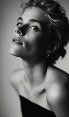 Fototapeta premium Close-up black and white portrait of a person with elegant expression and soft lighting, capturing timeless beauty and sophistication.