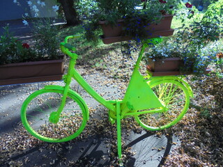 a very interesting and beautiful green bicycle in the park