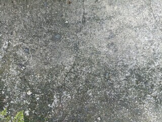 Rough Concrete Surface with Natural Weathered Texture. Close-up of a weathered concrete surface with rough texture, small stones, and moss details, perfect for backgrounds