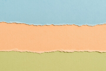 Pastel torn paper layers – blue, peach & green textured background