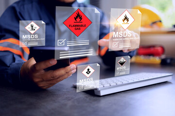 Flammable gas and hazardous substance concept with safety staff pointing on MSDS or materials safety data sheet dangerous goods detail on working desktop to categorize for shipping and storage area