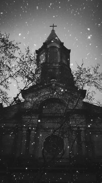 Low angle shot monochrome vertical video of christian church at snowtime 2d looped photo animation
