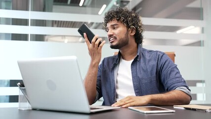 Angry businessman arguing talking on mobile phone sitting at workplace in office. Excited dissatisfied boss scolds subordinate. Manager dealing with stressful business situation or conflict resolution - Powered by Adobe