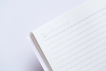 Close-up of blank notebook isolated on white background