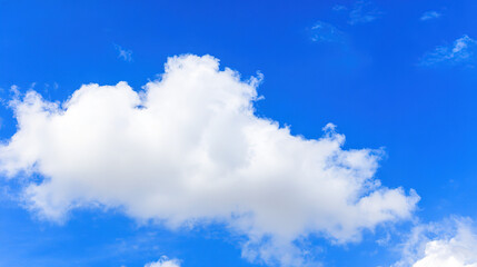 daylight. Fluffy white cloud against blue sky, minimalist nature composition with ample negative space and soft daylight. travel magazines.