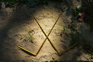 Dowsing with modern metal L-rods. Dowsing rods lie on the sand. An ancient method of finding water and treasure, not proven by modern science.