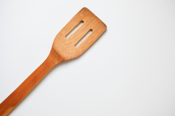 Close-up of bamboo kitchen spatula isolated on white background
