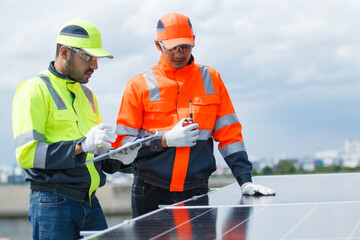 Engineers installing solar panels on rooftop for clean energy