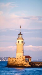 Lighthouse at sunset over water