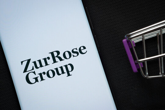 Dhaka, Bangladesh- 03 July 2025: A smartphone displaying the Zur Rose Group logo next to a miniature shopping cart on a background