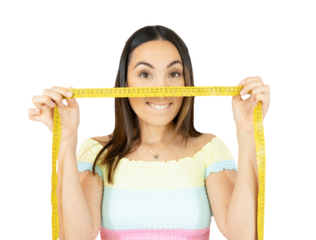 Joyful young woman holding measuring tape on face over transparent background. PNG transparent.