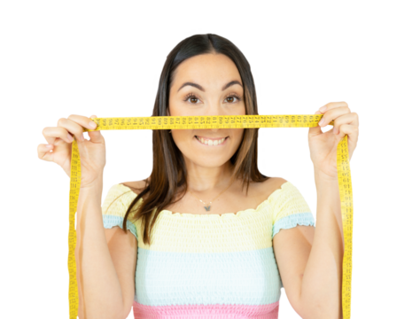 Joyful young woman holding measuring tape on face over transparent background. PNG transparent.