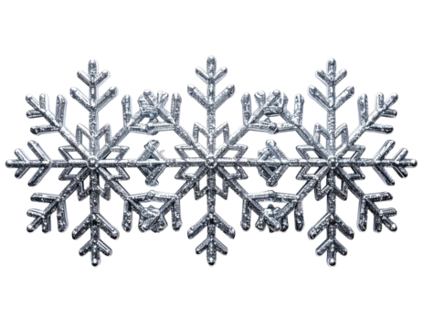 Close-up of three intricate silver snowflakes