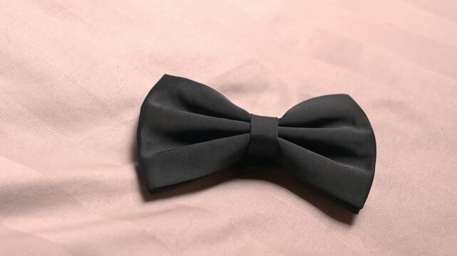 Bow ties arranged in a charming pattern highlight the elegance of a wedding celebration. Each bow tie showcases sophistication and style within the decor.