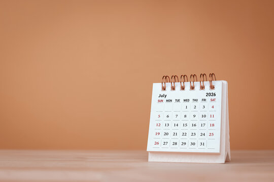 Calendar page July of the year 2026 on orange background. with copy space and business design. Concept of monthly planning, important schedules, meetings, and appointments.