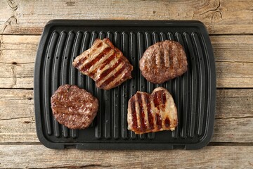 Delicious grilled beef meat on wooden table, top view