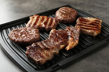 Delicious grilled beef meat on grey table, closeup