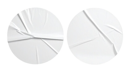 Two circular white crumpled paper or sticker shapes