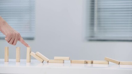 Hand Reaching Out to Stop Falling Dominoes Chain Reaction Prevention Concept